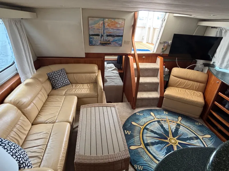 Slide: The Image of Interior of 2000 Silverton 453 Motor Yacht with beige seating and nautical decor. - 25