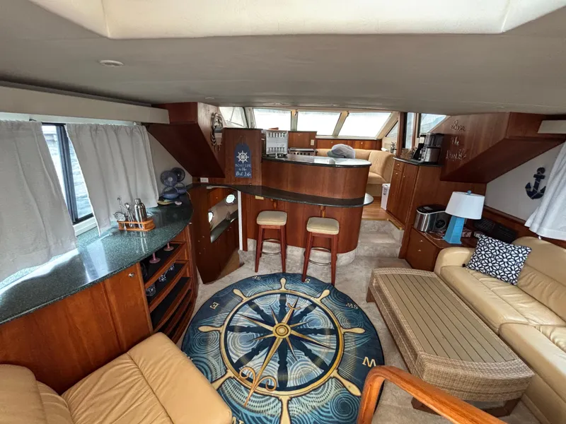 Slide: The Image of Interior of a 2000 Silverton 453 Motor Yacht with elegant wood finishes and nautical decor. - 26