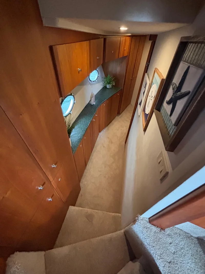 Slide: The Image of Interior hallway of 2000 Silverton 453 Motor Yacht with wood cabinets and porthole windows. - 27