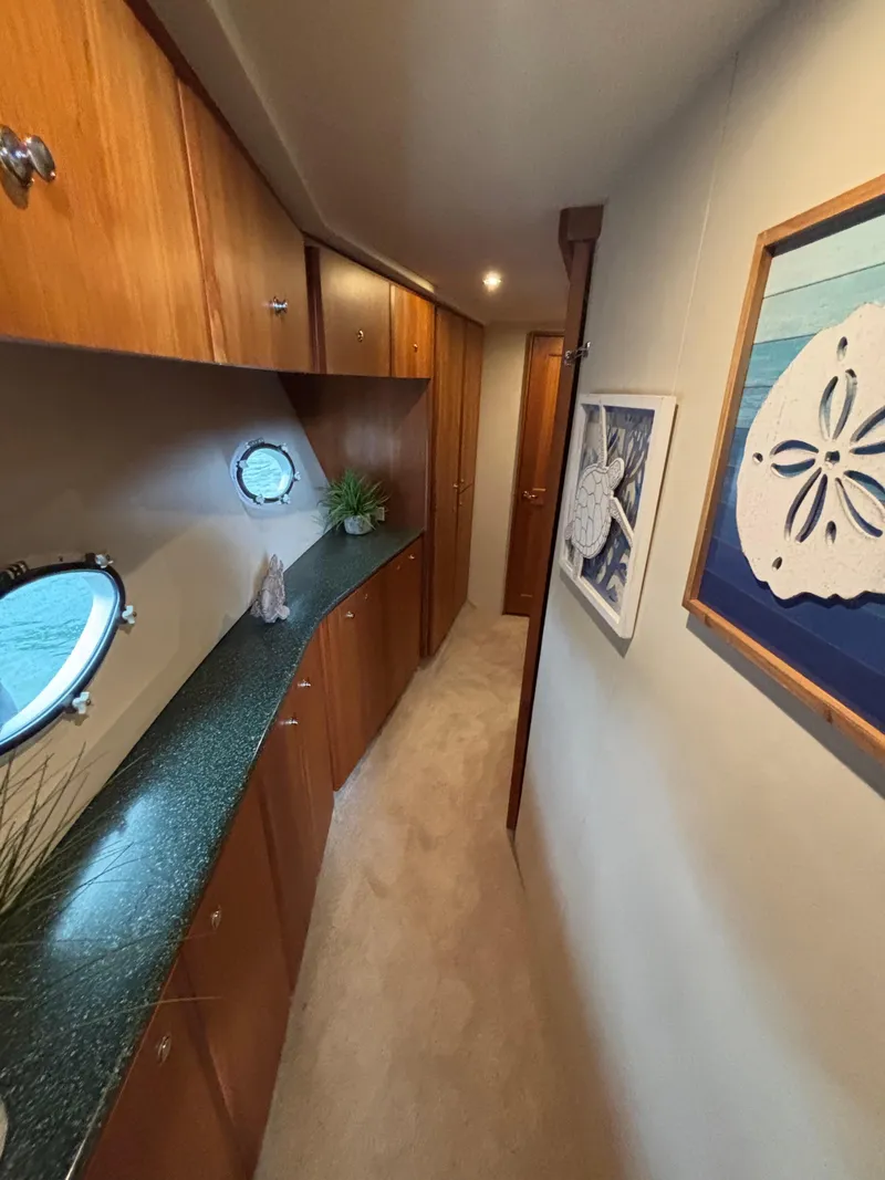 Slide: The Image of Interior hallway of 2000 Silverton 453 Motor Yacht with wood cabinets and nautical decor. - 28