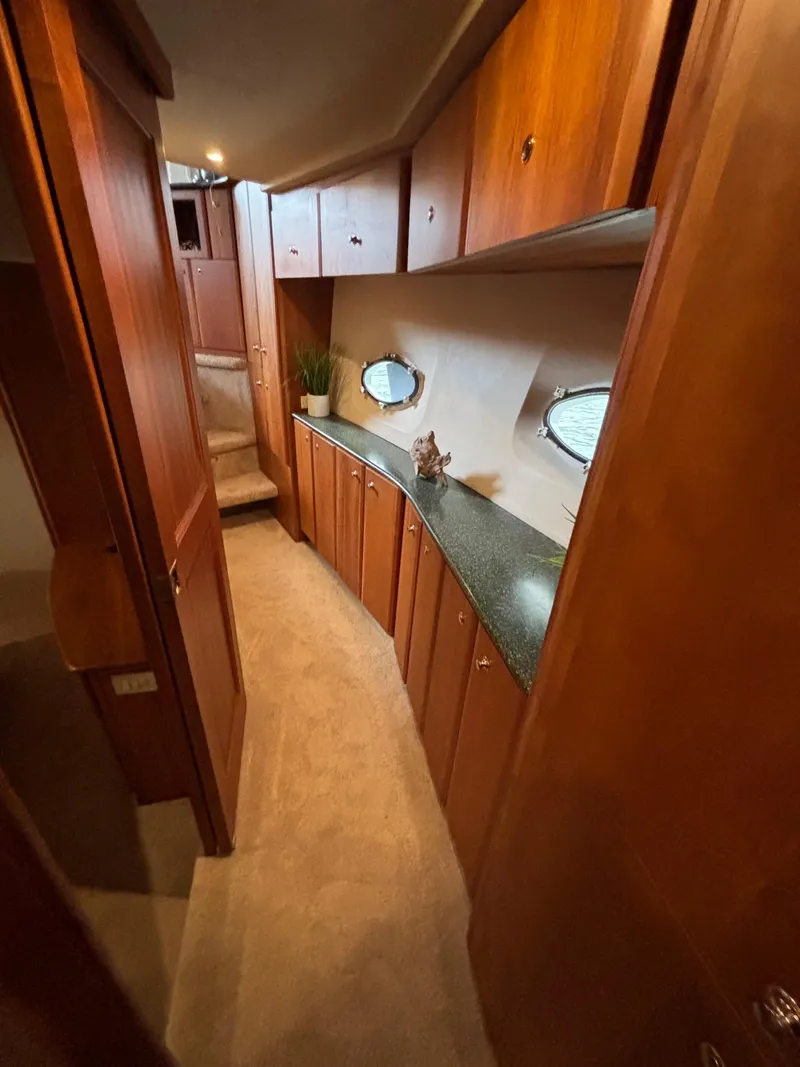 Slide: The Image of Interior of 2000 Silverton 453 Motor Yacht with wood cabinetry and porthole windows. - 33