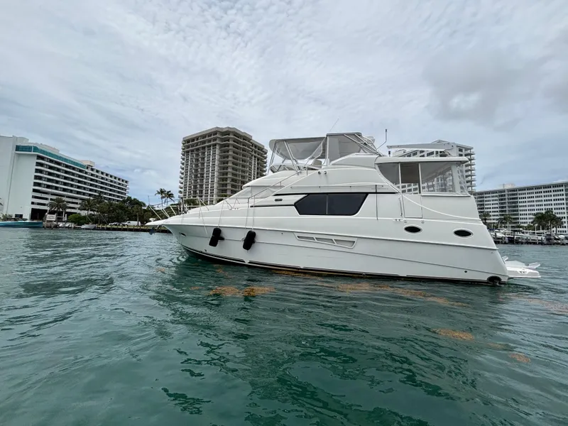 Slide: The Image of 2000 Silverton 453 Motor Yacht on water near urban buildings. - 7