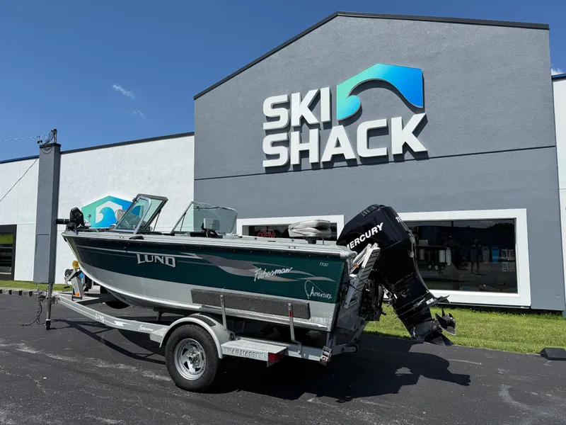 Slide: The Image of 2005 Lund 1700 Fisherman boat on trailer outside Ski Shack store. - 2
