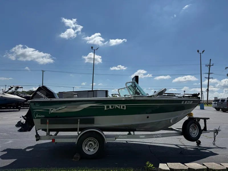 Slide: The Image of 2005 Lund 1700 Fisherman boat on trailer under clear blue sky. - 3