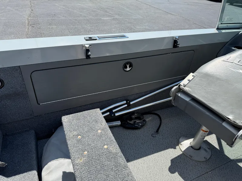 Slide: The Image of Interior of a 2005 Lund 1700 Fisherman boat, featuring seating and storage compartments. - 7