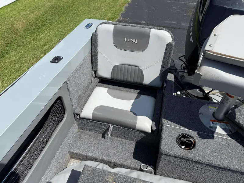 Slide: The Image of 2005 Lund 1700 Fisherman boat interior with gray seating and carpeted flooring. - 8