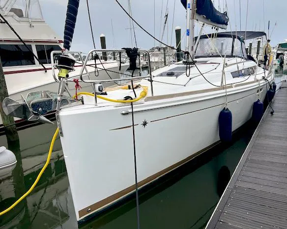 The Image of 2018 Jeanneau Sun Odyssey 389 sailboat docked at marina, side view. - 0
