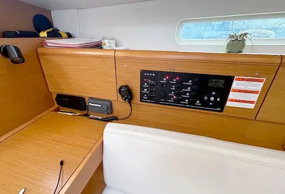 Slide: The Image of Interior of 2018 Jeanneau Sun Odyssey 389 yacht with control panel and wooden finish. - 10