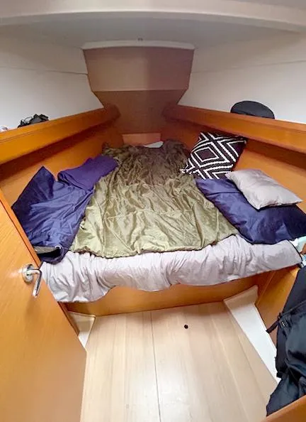 Slide: The Image of Cozy cabin interior of 2018 Jeanneau Sun Odyssey 389 sailboat with bed and pillows. - 11