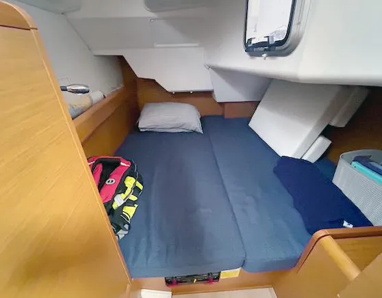 Slide: The Image of Cozy cabin interior of 2018 Jeanneau Sun Odyssey 389 sailboat with bed and window. - 12