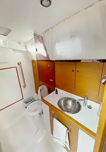 Slide: The Image of Bathroom interior of 2018 Jeanneau Sun Odyssey 389 yacht, featuring sink and toilet. - 13