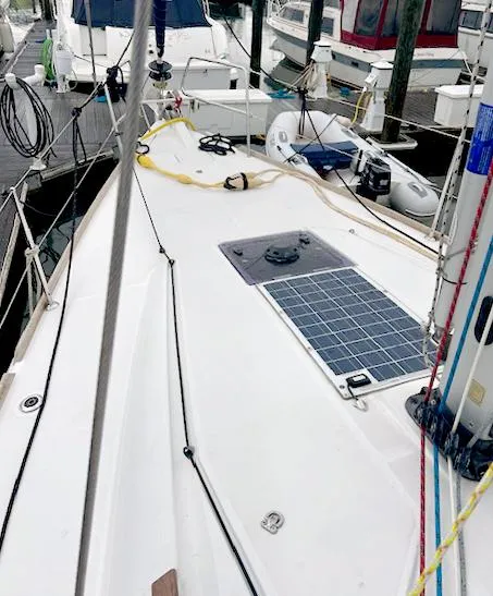 Slide: The Image of 2018 Jeanneau Sun Odyssey 389 sailboat deck with solar panel, docked at marina. - 3