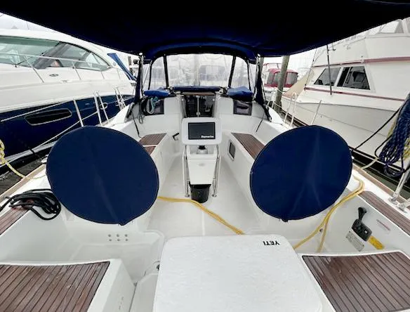 Slide: The Image of Cockpit of 2018 Jeanneau Sun Odyssey 389 sailboat with blue covers and modern navigation equipment. - 4