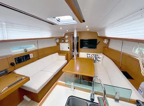 Slide: The Image of Interior of 2018 Jeanneau Sun Odyssey 389 yacht with modern seating and dining area. - 5