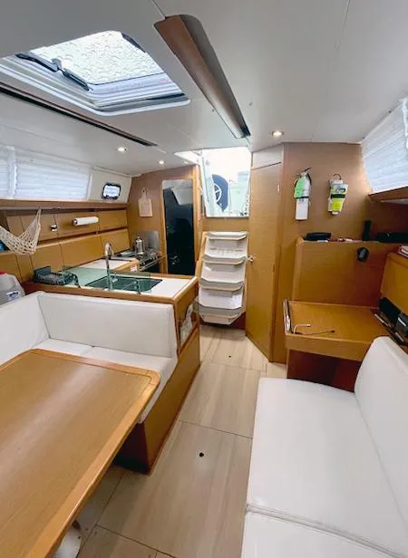 Slide: The Image of Interior of 2018 Jeanneau Sun Odyssey 389 sailboat with modern wood finish and seating area. - 6