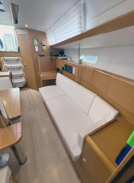 Slide: The Image of Interior of 2018 Jeanneau Sun Odyssey 389 yacht with white sofa and wooden accents. - 7