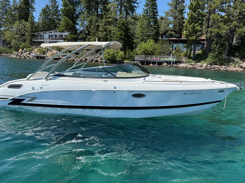 Slide: The Image of 2013 Formula 290 Bowrider on clear lake with forested shoreline. - 0