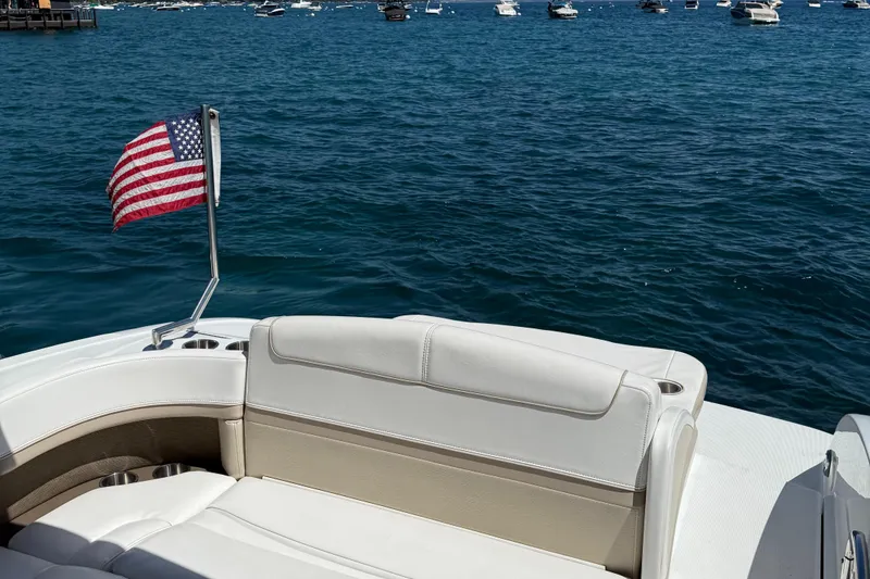 Slide: The Image of 2013 Formula 290 Bowrider with American flag, on a serene blue ocean. - 15