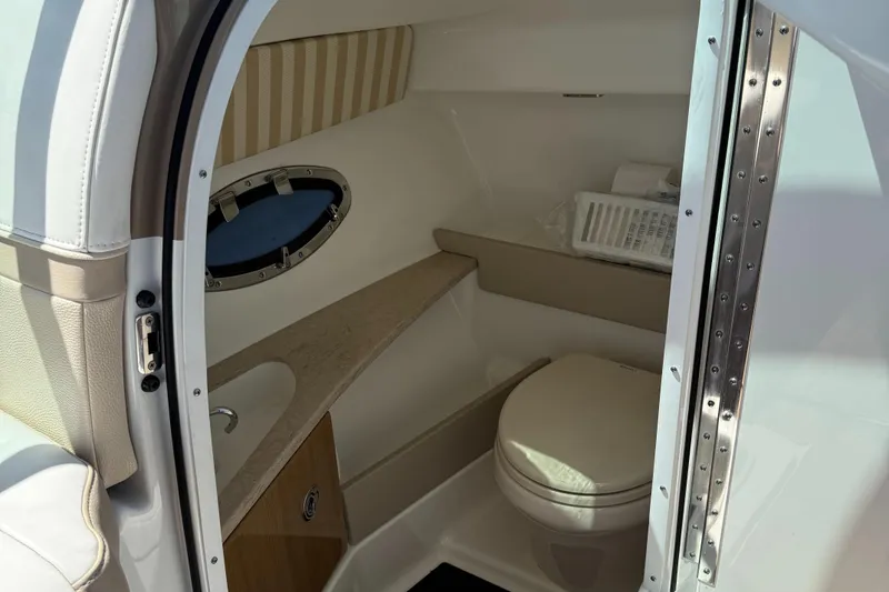 Slide: The Image of Interior of 2013 Formula 290 Bowrider boat bathroom with toilet and sink. - 19