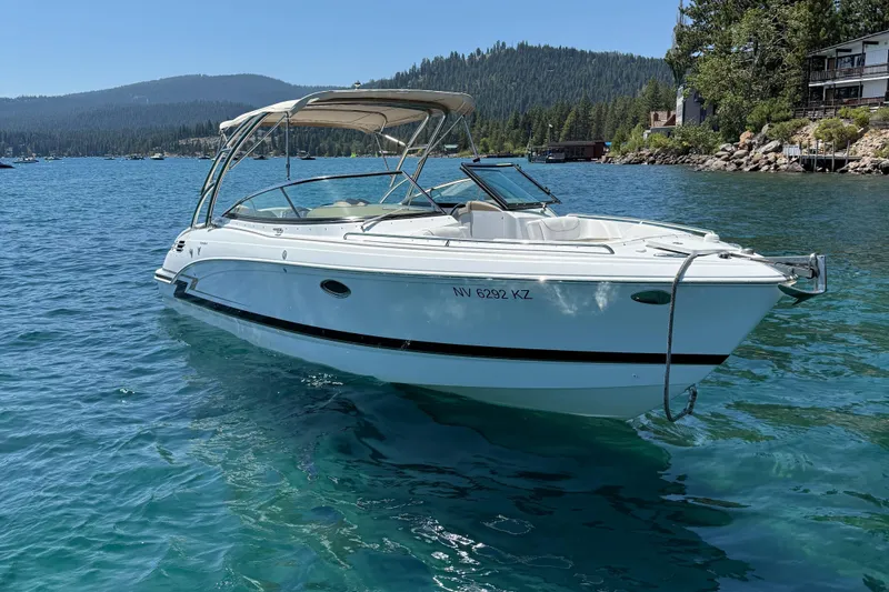 Slide: The Image of 2013 Formula 290 Bowrider on a scenic lake with forested hills in the background. - 2