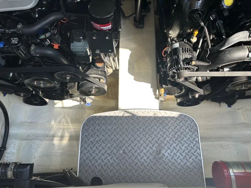 Slide: The Image of Engine compartment of a 2013 Formula 290 Bowrider boat, showcasing dual engines and components. - 23