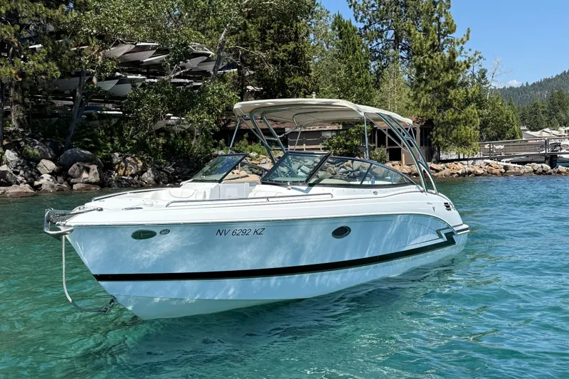Slide: The Image of 2013 Formula 290 Bowrider boat on clear water, surrounded by trees and rocks. - 3