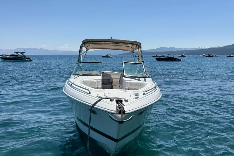 Slide: The Image of 2013 Formula 290 Bowrider on a serene lake with distant boats and mountains. - 4