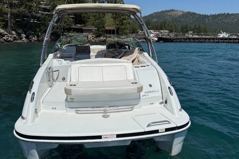 Slide: The Image of 2013 Formula 290 Bowrider boat on clear blue water, surrounded by scenic mountains. - 5