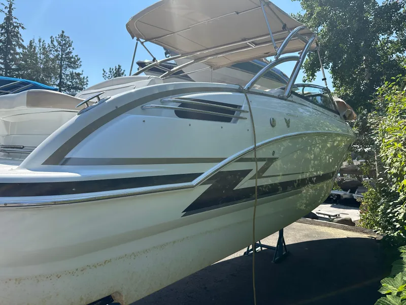 Slide: The Image of 2013 Formula 290 Bowrider boat with canopy, parked outdoors on a sunny day. - 6