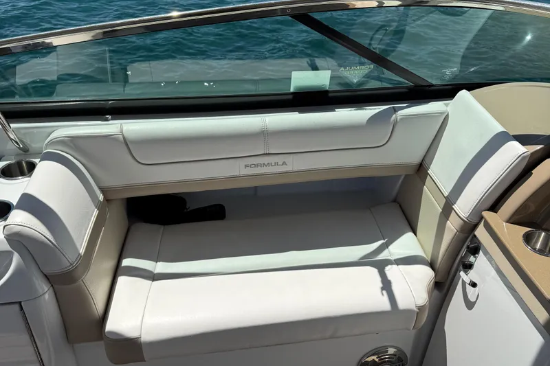 Slide: The Image of 2013 Formula 290 Bowrider boat interior with white seating and cup holders. - 9