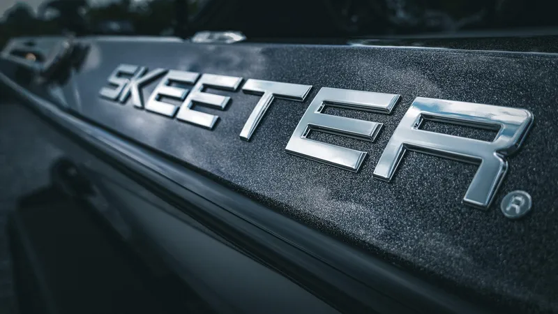 Slide: The Image of 2026 Skeeter ZXE 20 boat logo in metallic finish, close-up view. - 13