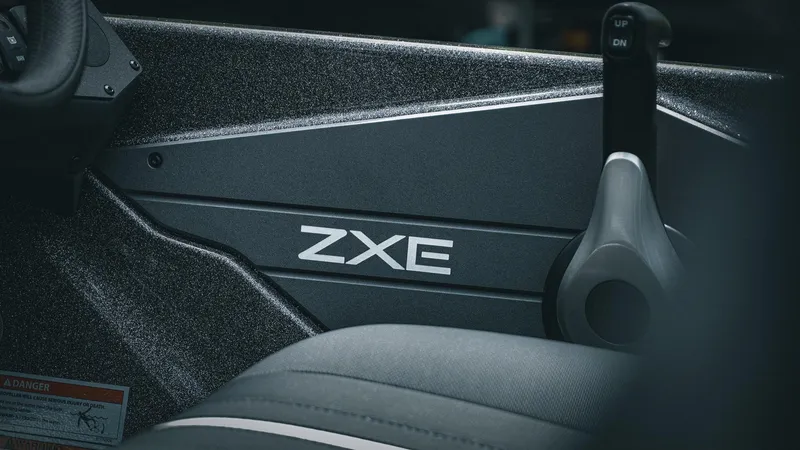 Slide: The Image of 2026 Skeeter ZXE 20 boat interior with control lever and branding. - 16