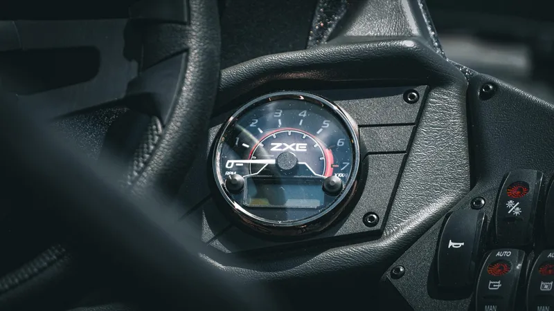 Slide: The Image of Close-up of 2026 Skeeter ZXE 20 dashboard with tachometer and control buttons. - 18