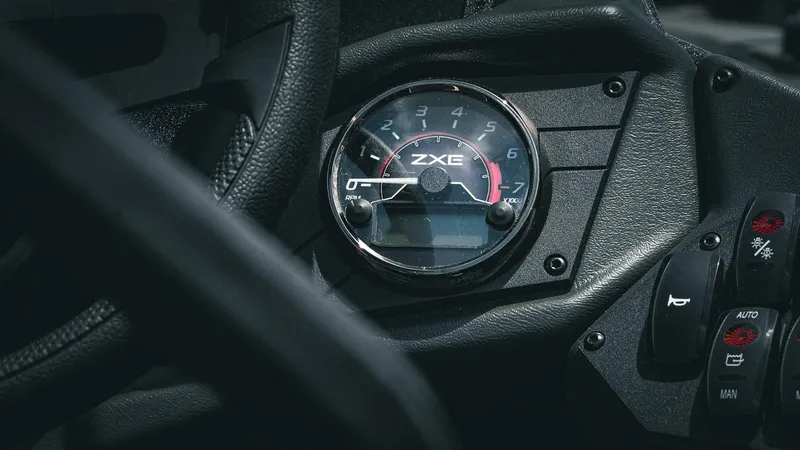 Slide: The Image of 2026 Skeeter ZXE 20 dashboard with tachometer and control buttons. - 19