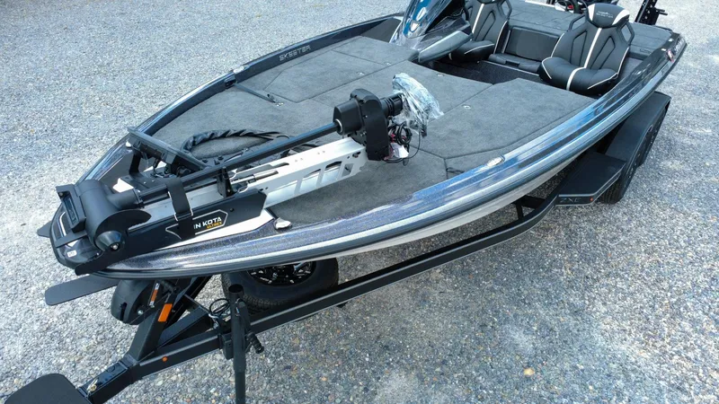 Slide: The Image of 2026 Skeeter ZXE 20 fishing boat on trailer, featuring Minn Kota trolling motor. - 2