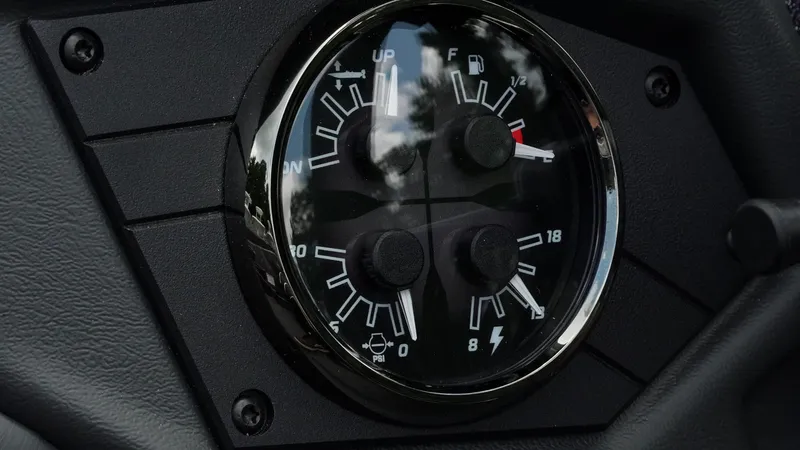 Slide: The Image of Dashboard gauges of 2026 Skeeter ZXE 20 boat, showing fuel and system indicators. - 21