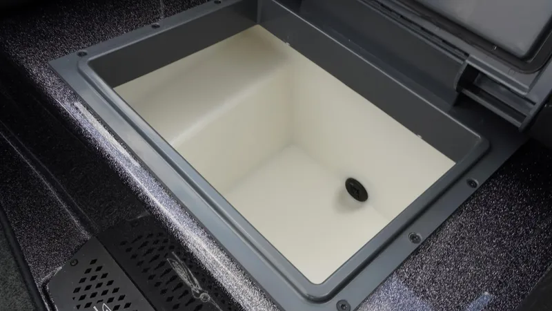 Slide: The Image of Open storage compartment in 2026 Skeeter ZXE 20 boat, featuring a sleek design. - 26