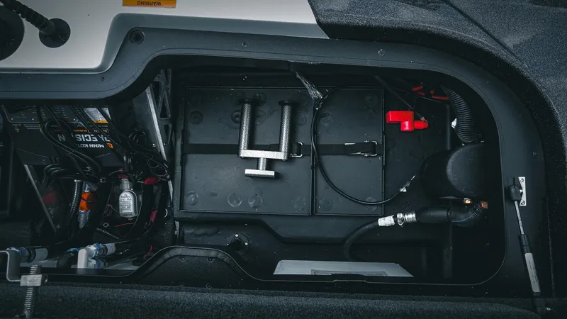 Slide: The Image of 2026 Skeeter ZXE 20 boat battery compartment with wiring and components. - 30