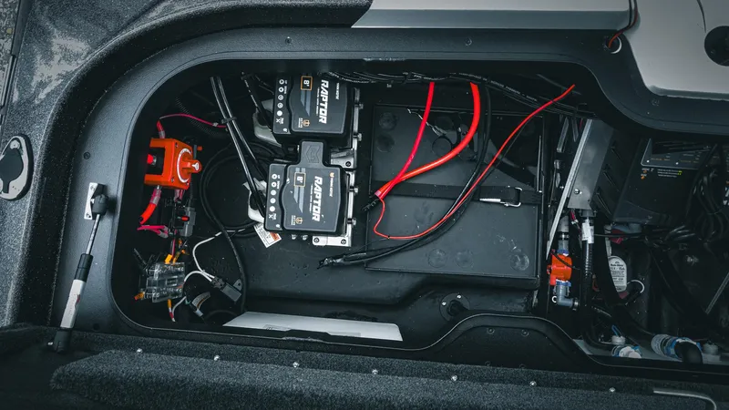 Slide: The Image of 2026 Skeeter ZXE 20 boat battery compartment with wiring and components. - 32