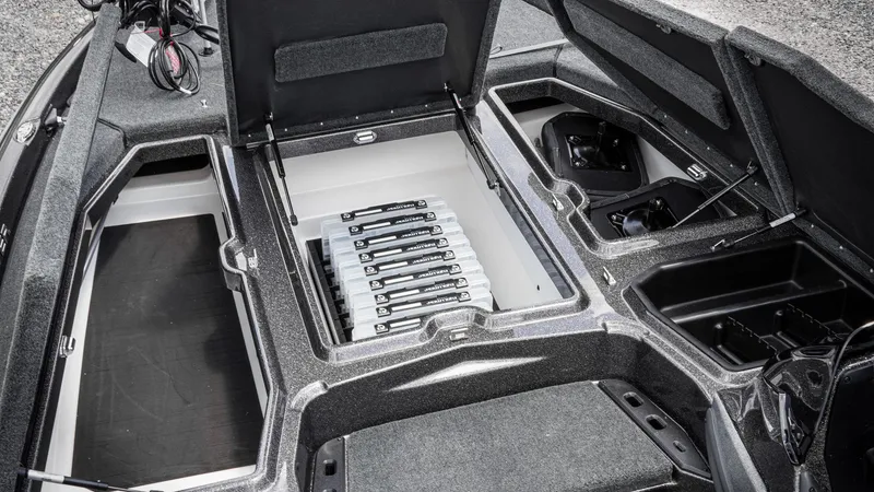 Slide: The Image of 2026 Skeeter ZXE 20 boat interior with open storage compartments and organized tackle boxes. - 36