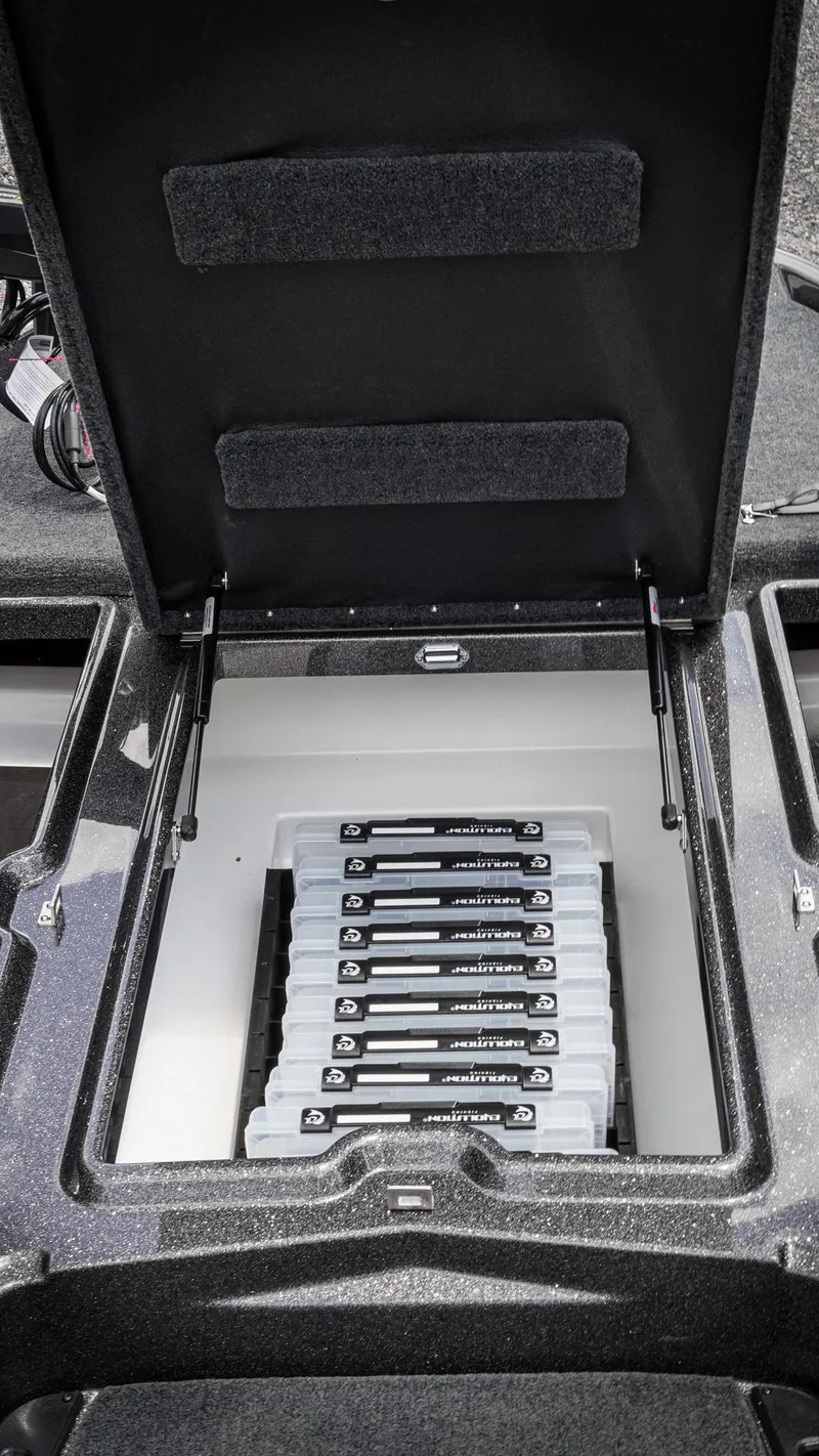 Slide: The Image of Open storage compartment in 2026 Skeeter ZXE 20 boat, showcasing organized tackle boxes. - 37
