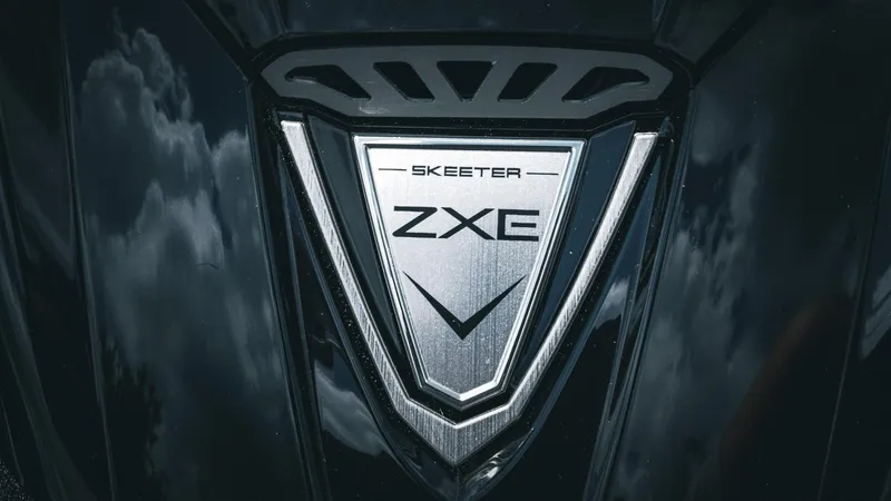 Slide: The Image of Close-up of 2026 Skeeter ZXE 20 emblem with reflective surface and cloud reflections. - 40