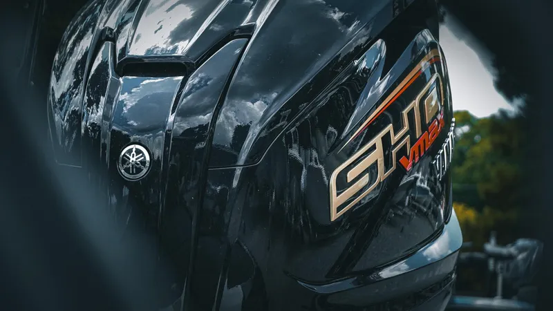 Slide: The Image of 2026 Skeeter ZXE 20 outboard motor with Yamaha SHO VMAX branding, reflecting sky and trees. - 9