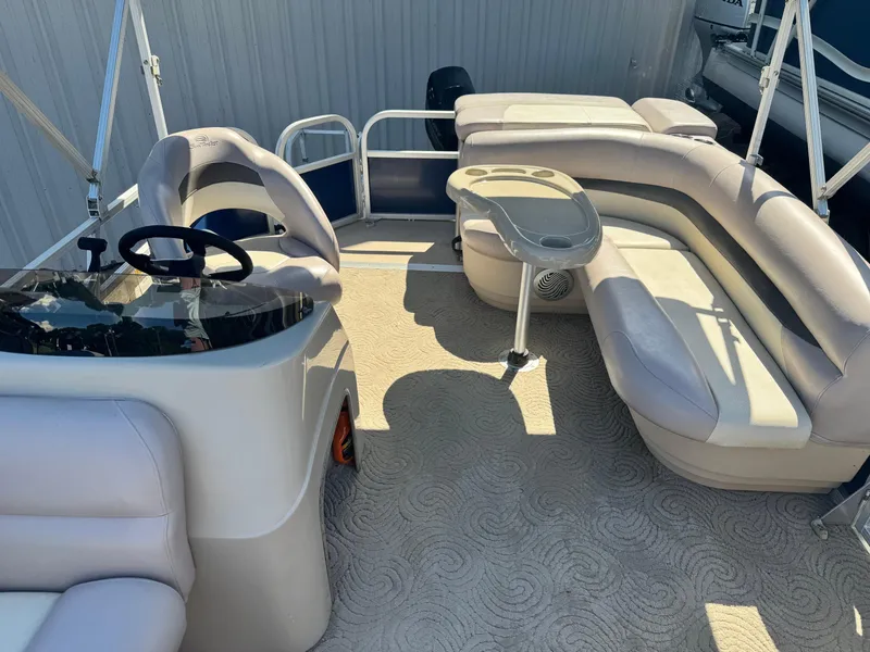 Slide: The Image of 2014 Sun Tracker Party Barge 20 DLX interior with seating and steering console. - 3