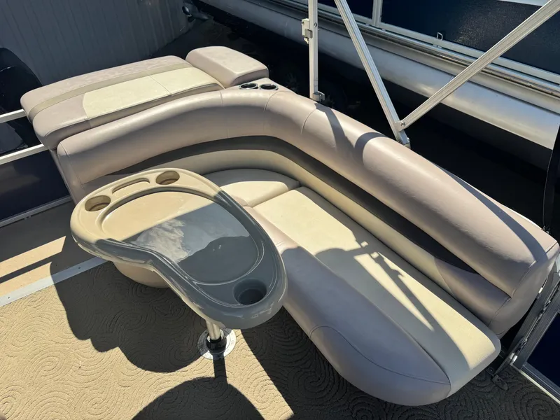 Slide: The Image of 2014 Sun Tracker Party Barge 20 DLX interior with curved seating and table. - 4