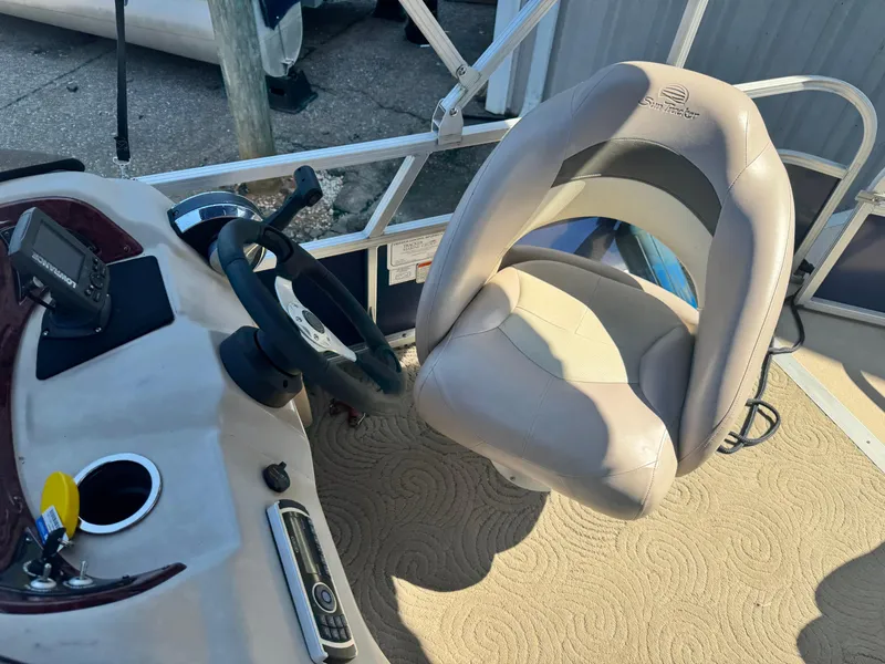 Slide: The Image of 2014 Sun Tracker Party Barge 20 DLX helm with steering wheel and captain's chair. - 5