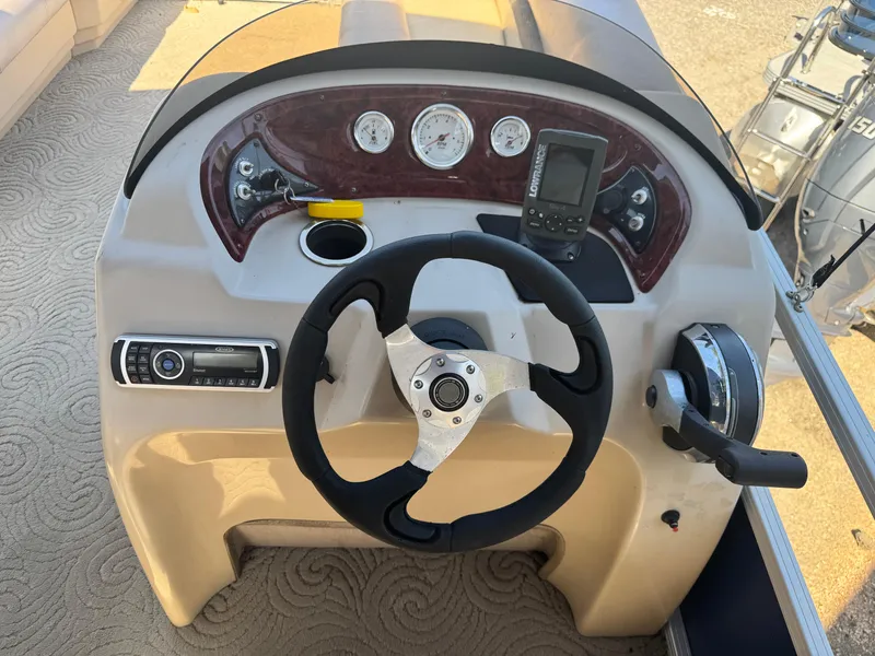 Slide: The Image of 2014 Sun Tracker Party Barge 20 DLX dashboard with steering wheel and controls. - 6