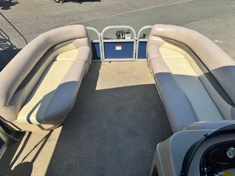 Slide: The Image of 2014 Sun Tracker Party Barge 20 DLX interior with beige seating and carpeted floor. - 7