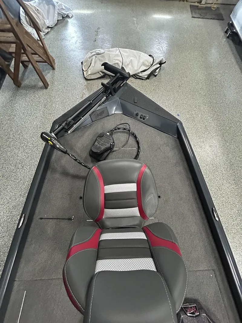 Slide: The Image of 2022 Ranger RT178C boat interior with gray and red seating, steering console, and carpeted floor. - 10