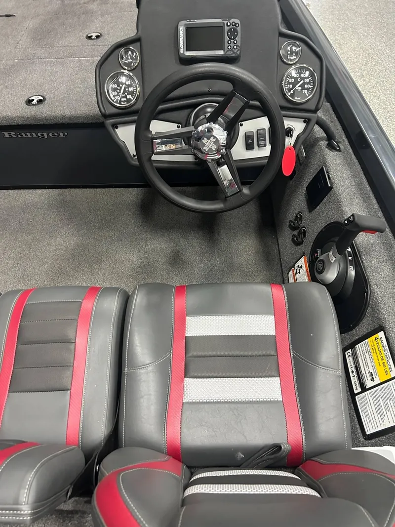 Slide: The Image of Open storage compartment in 2022 Ranger RT178C boat, featuring a gray interior and carpeted exterior. - 14